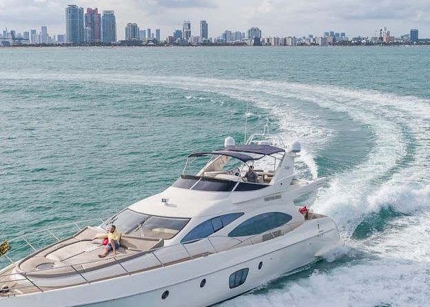 An aerial view of a yacht floating on top of a body of water.