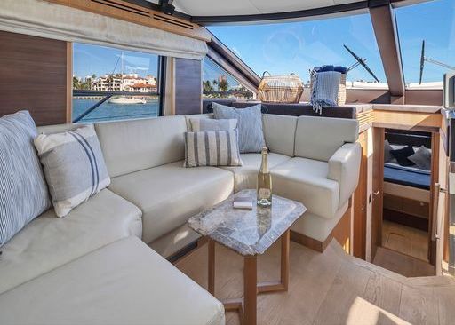 A living room on a boat with a couch and a table.