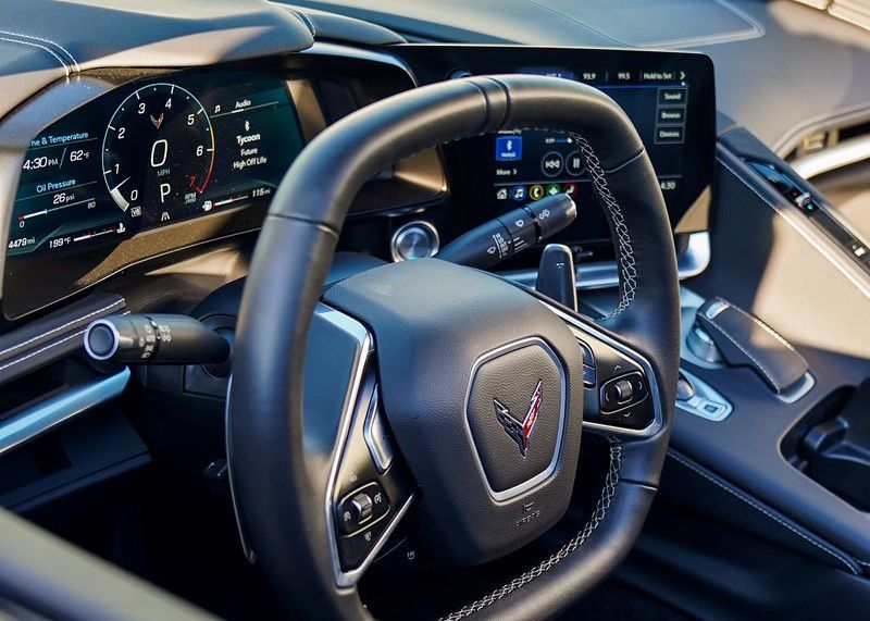 A close up of the steering wheel and dashboard of a car.