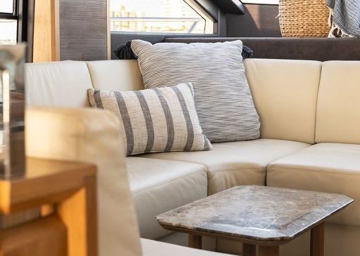 A living room with a couch, table and pillows.