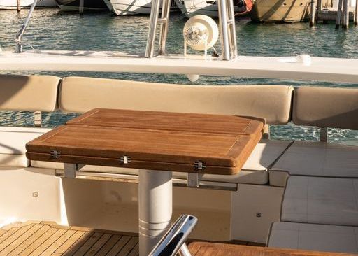 A wooden table is sitting on the back of a boat.