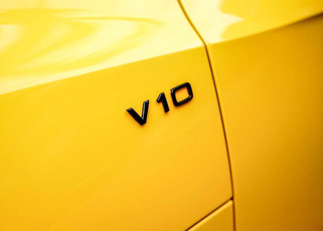A close up of a yellow car with the letters V10 on the side.