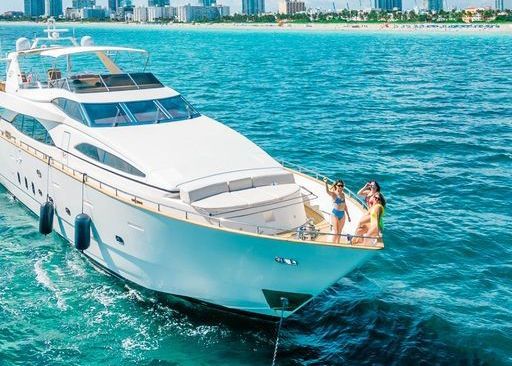 A large white yacht is floating on top of a large body of water.