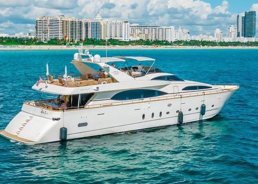 A large white yacht is floating on top of a body of water.