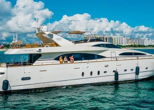 A large white yacht is floating on top of a body of water.