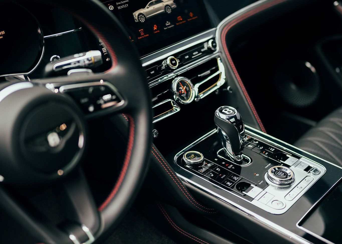 A close up of the steering wheel and dashboard of a car.