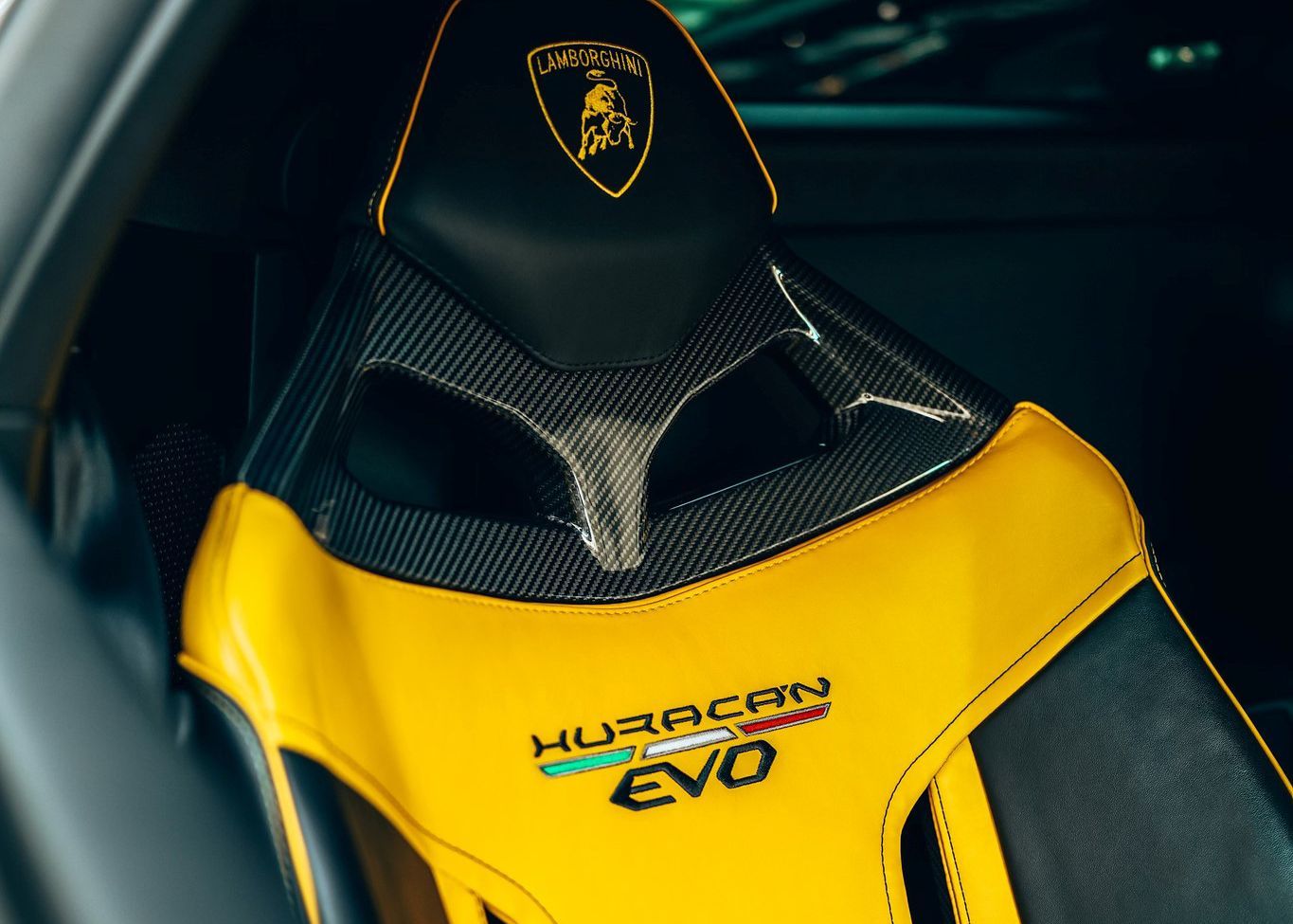 A close up of a yellow and black Lamborghini Evo seat.