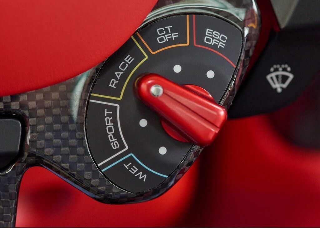 A close up of a steering wheel with the word race on it.