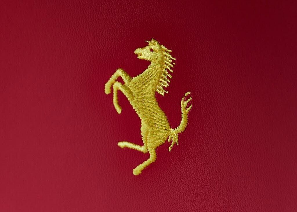 A gold horse is embroidered on a red background.