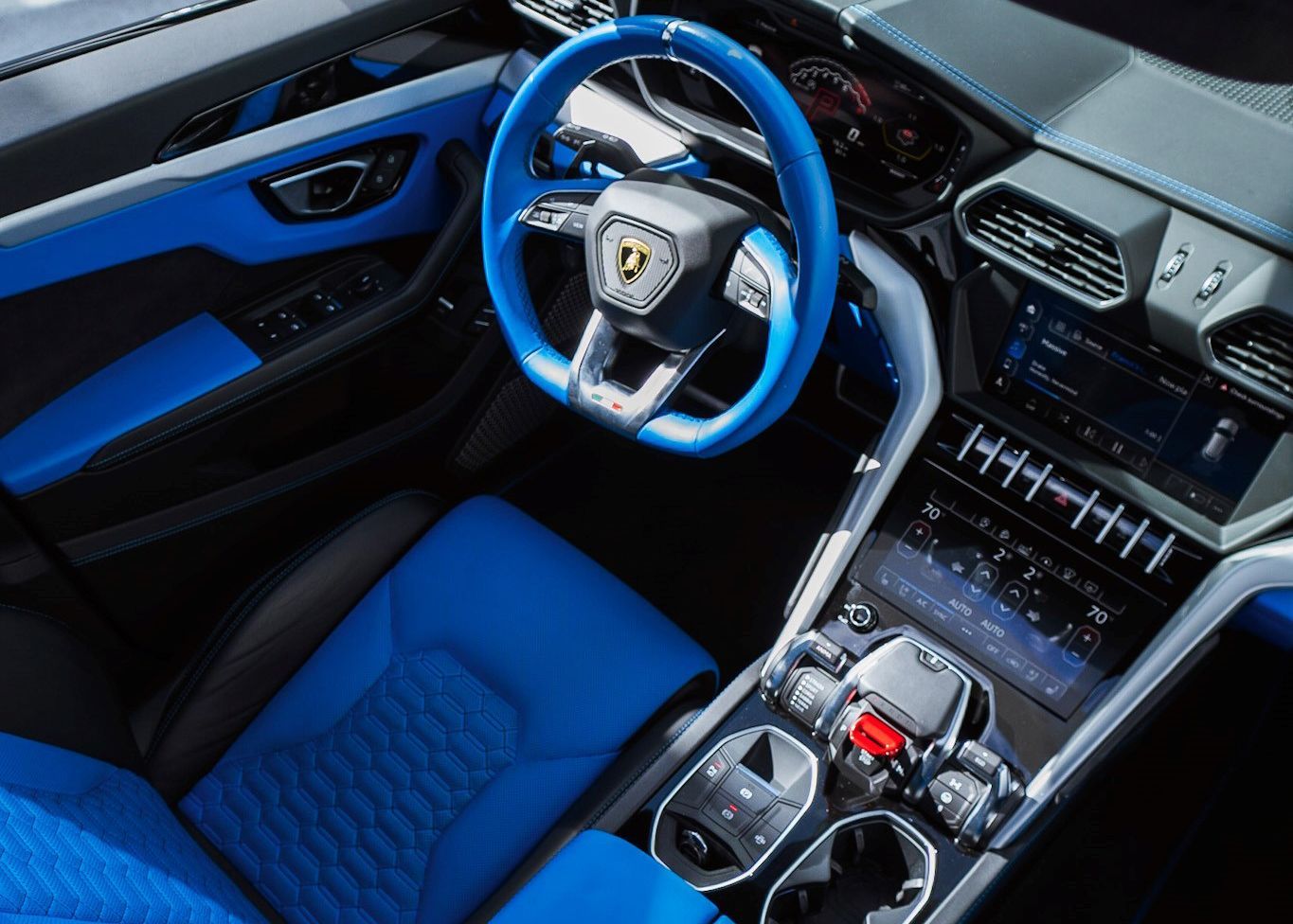 The interior of a car with blue seats and a blue steering wheel.