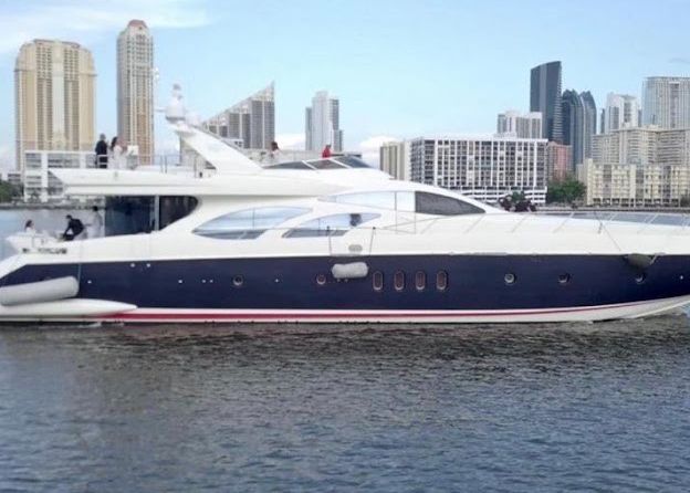 A large yacht is floating on top of a body of water.