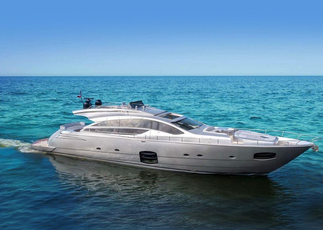 A large white yacht is floating on top of a large body of water.