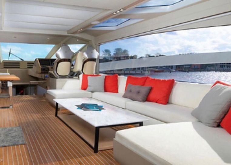 A living room on a boat with a couch and a table.