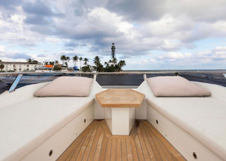 A boat with a table and cushions on the deck.