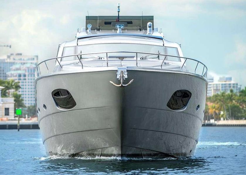 A large gray yacht is floating on top of a body of water.