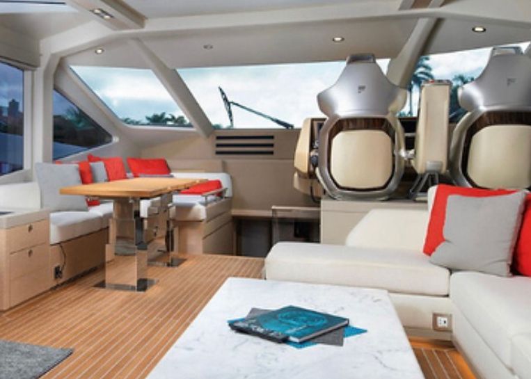 A living room on a boat with a table and chairs.