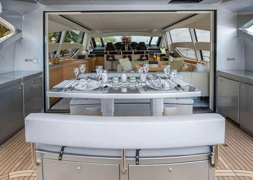 The inside of a yacht with a table set for a dinner party.