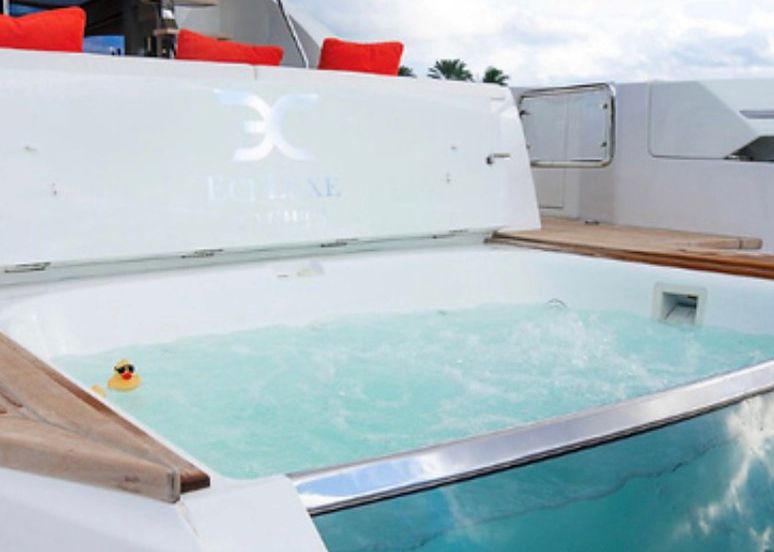 A duck is swimming in a jacuzzi on the back of a boat.