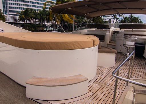 A boat with a large round cushion on the deck.