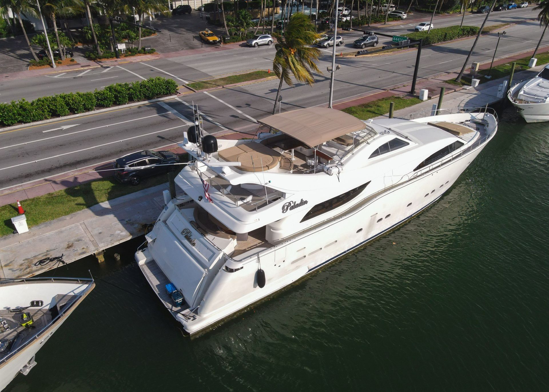 An aerial view of a large white yacht docked in a harbor.