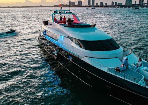 A large yacht is floating on top of a large body of water.