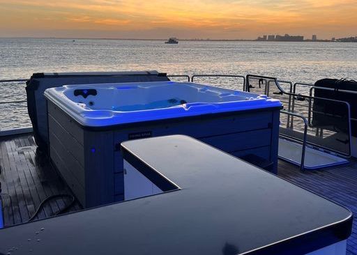 There is a hot tub on the deck of a boat.