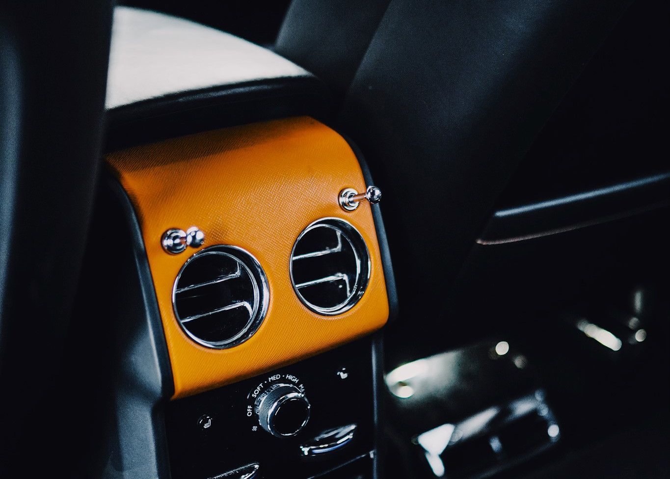 A close up of a car dashboard with two air vents.