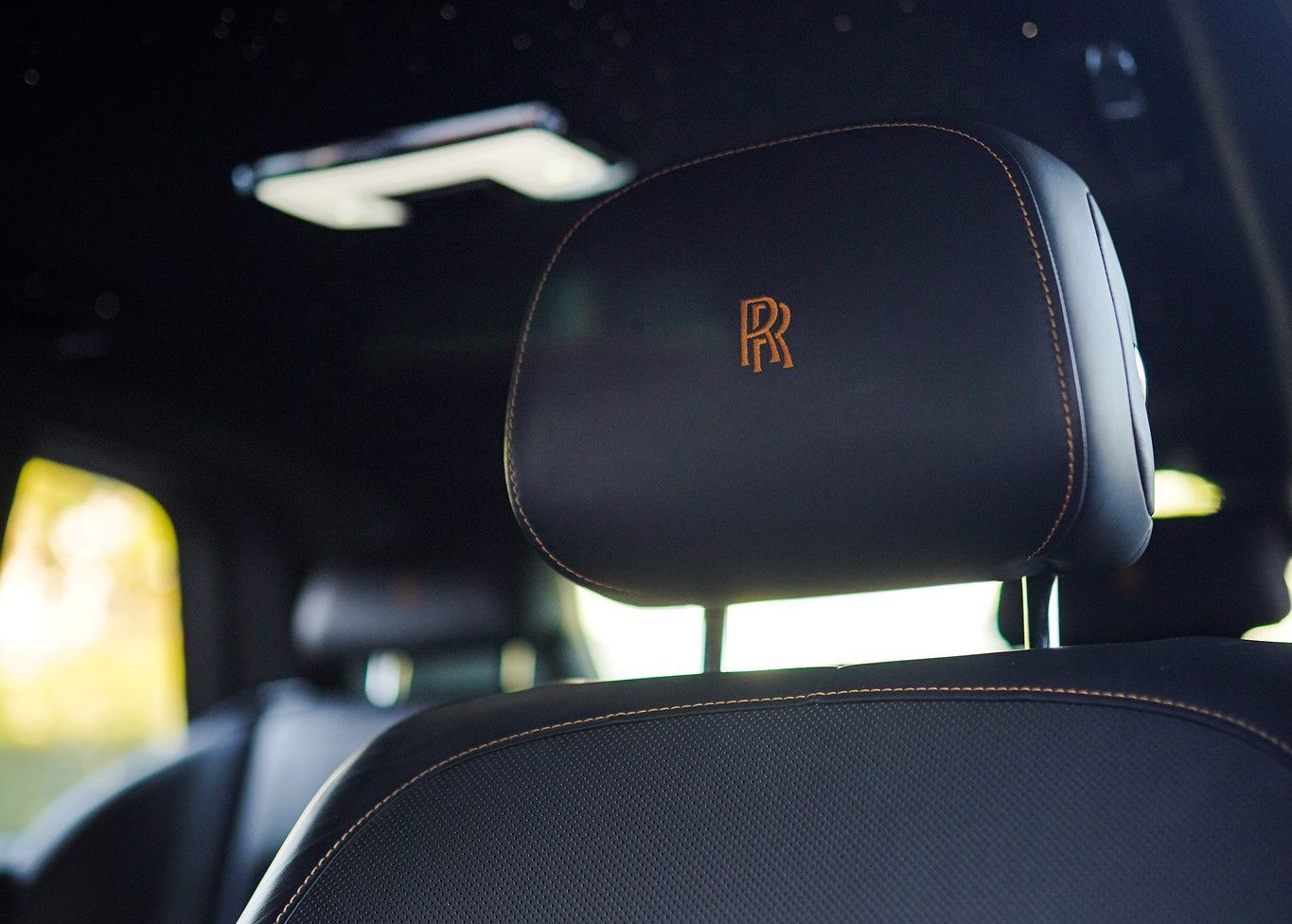 A close up of a Rolls Royce headrest in a car.