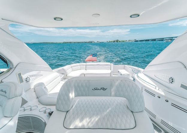 A white boat is floating on top of a body of water.