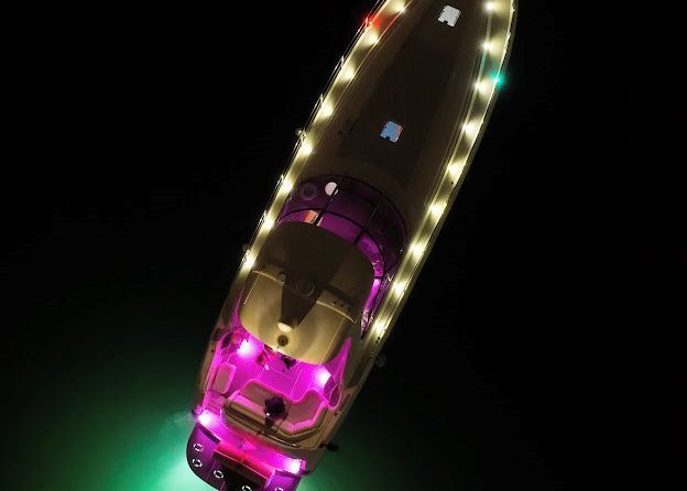 An aerial view of a boat decorated with christmas lights.