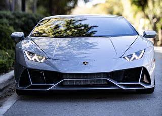 A gray Lamborghini Huracan is parked on the side of the road.
