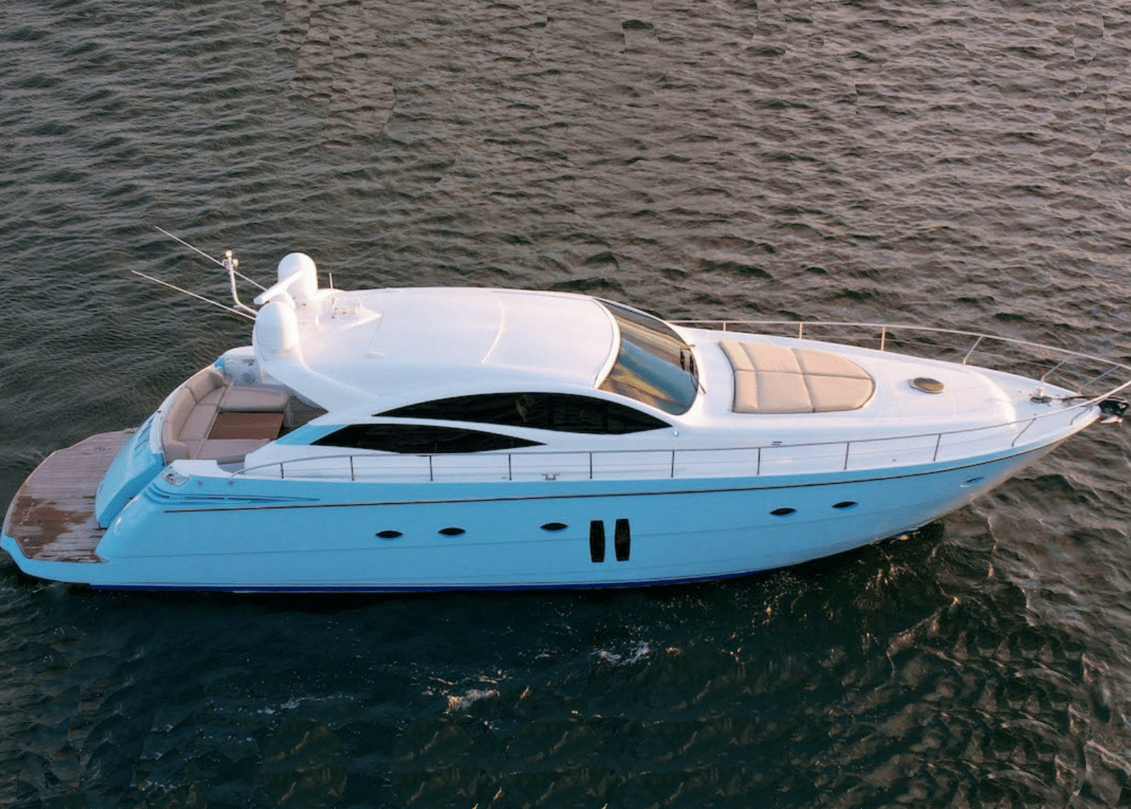 A white yacht is floating on top of a body of water.