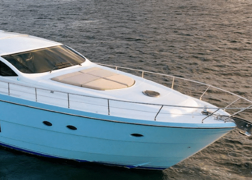 A white boat is floating on top of a body of water.