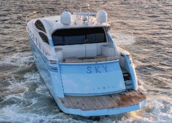 A blue and white yacht is floating on top of a body of water.