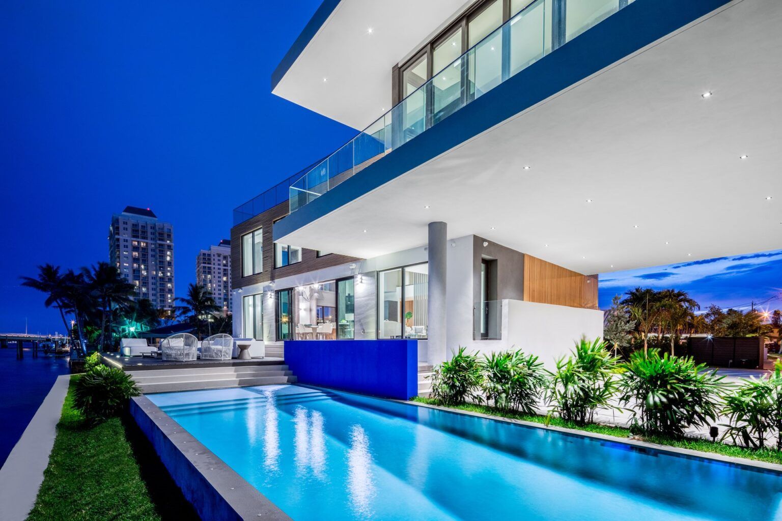 A large house with a swimming pool in front of it.