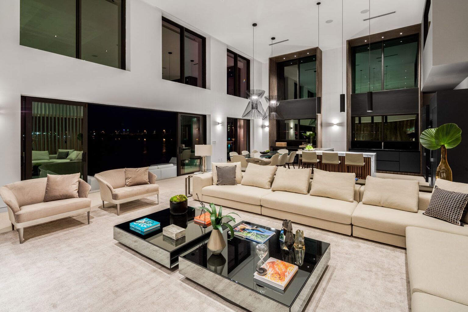 A living room with a couch, chairs, and two coffee tables.