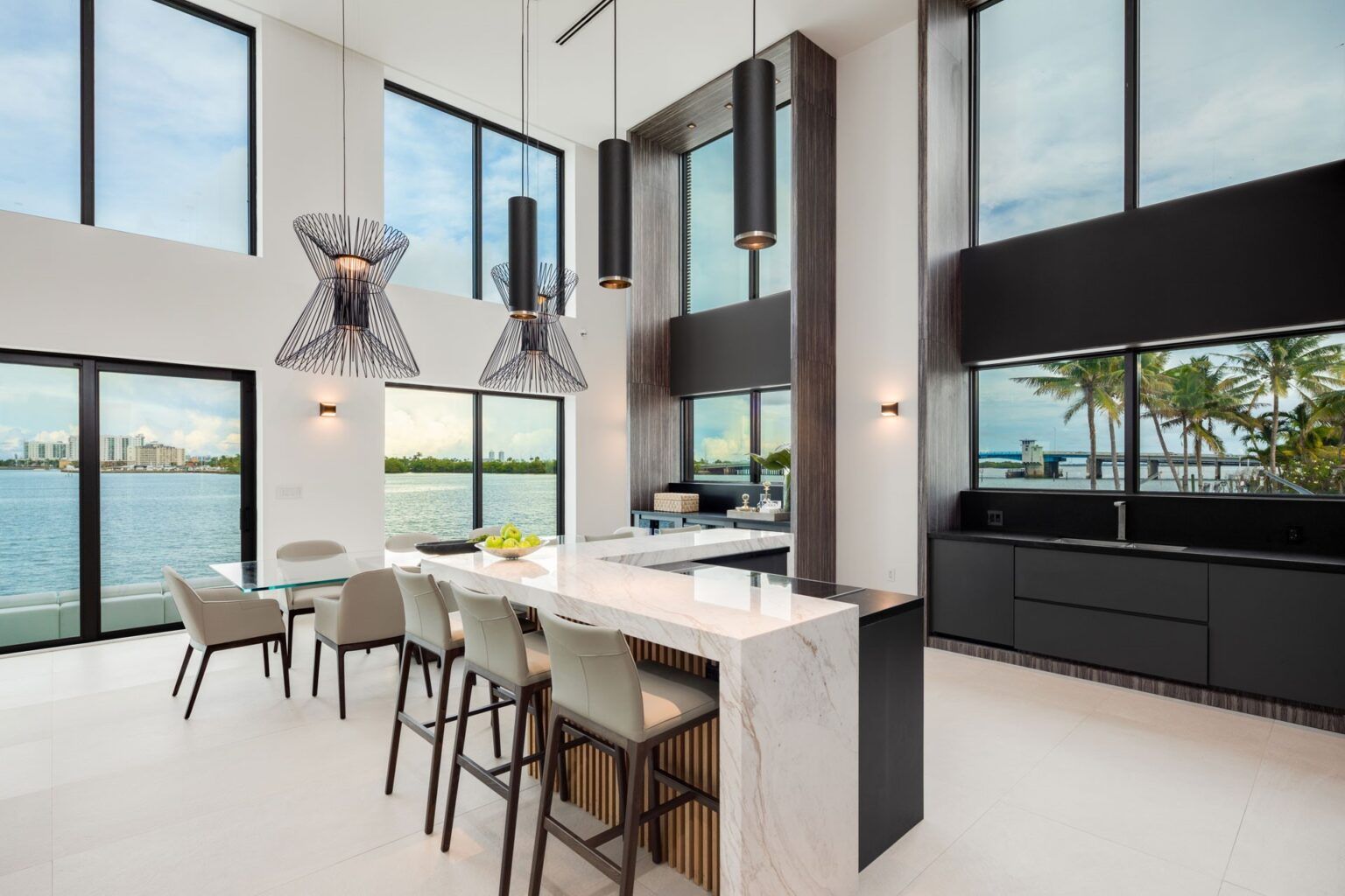 A kitchen with a dining table and chairs and a large island.