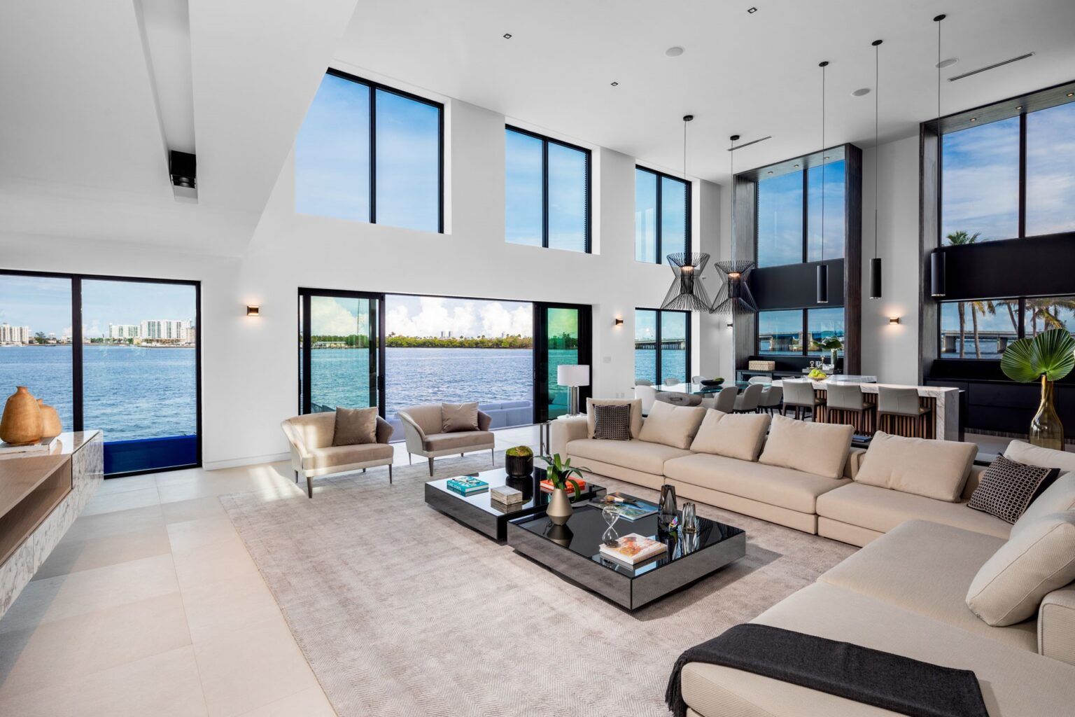 A living room with a lot of furniture and a view of the ocean.