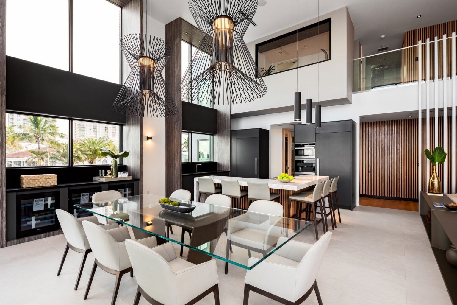 A modern dining room with a glass table and chairs.