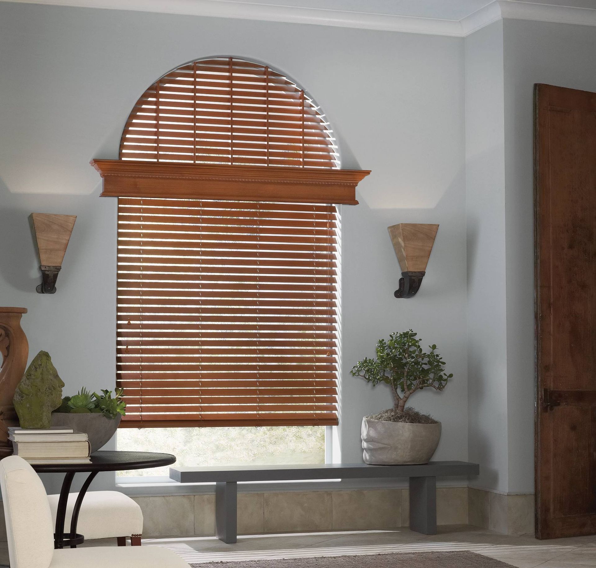 Wooden arched blinds covering a window in a traditional living room near Toledo, Ohio