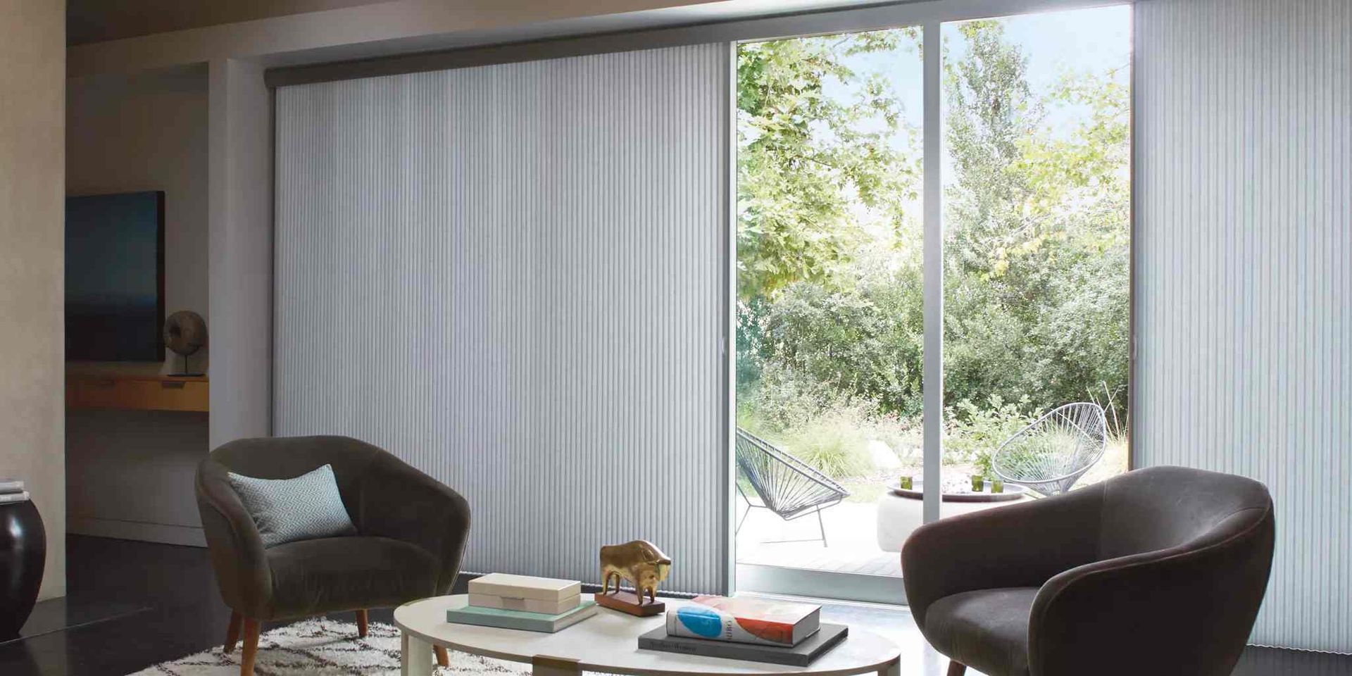Hunter Douglas sliding door window treatments in a modern living room near Toledo, OH.