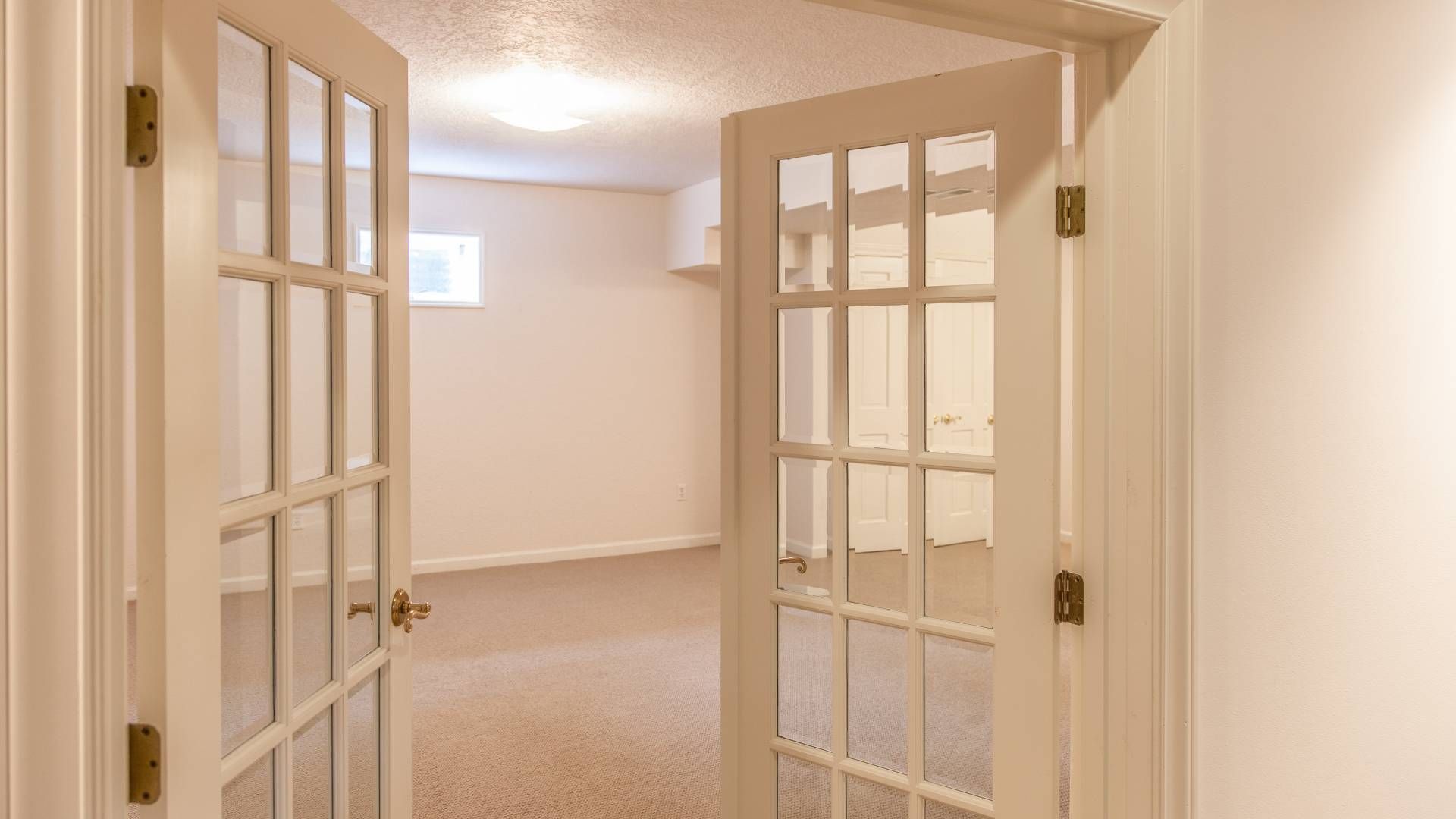 Two white French doors in an empty home near Toledo, OH