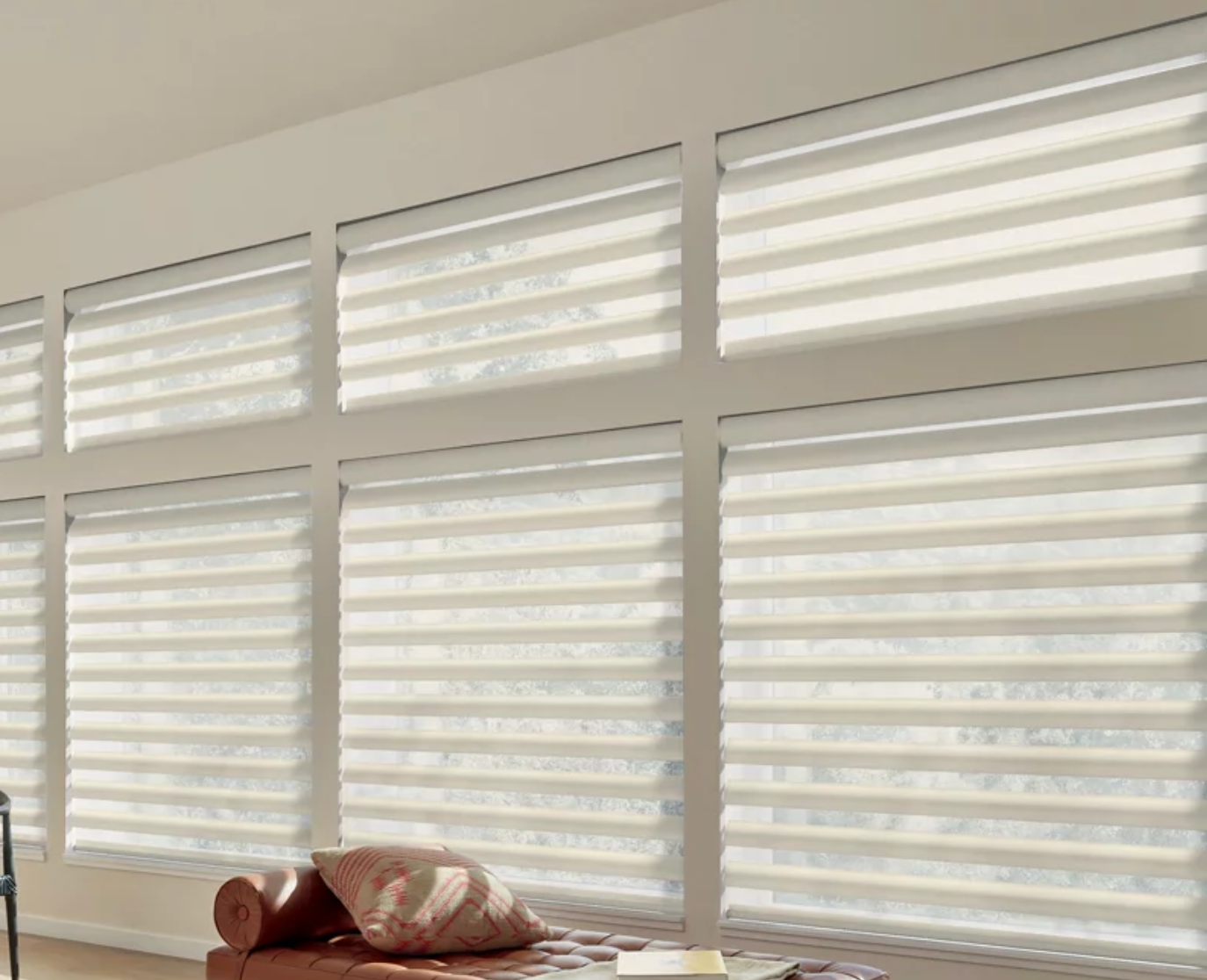 Hunter Douglas Pirouette® Sheer Shades covering multiple windows in a living room. 