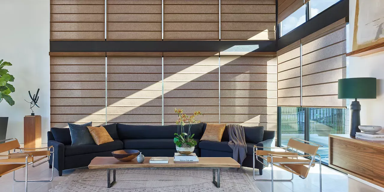 Hunter Douglas woven roller shades in a modern living room.
