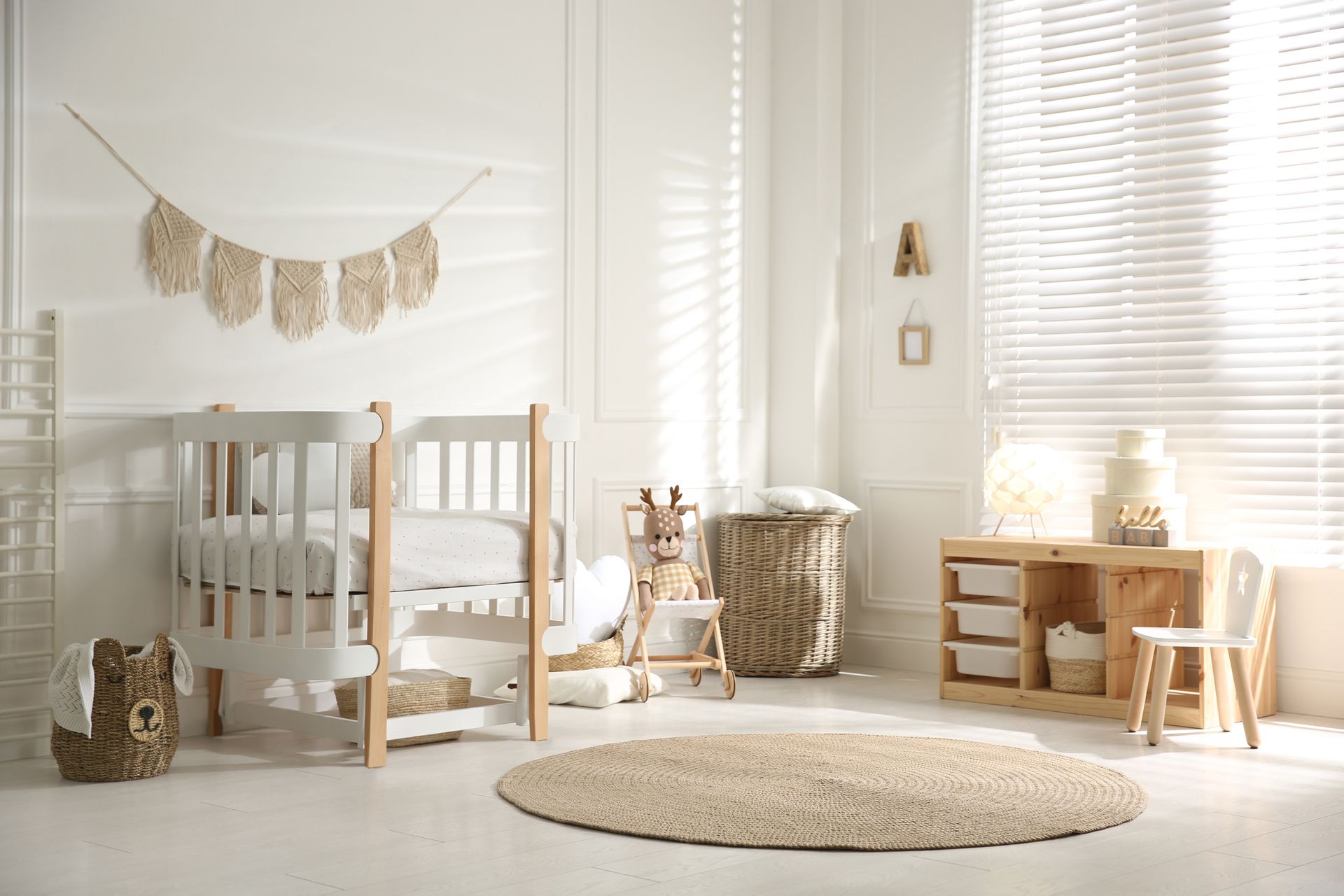 Modern nursery with crib, changing table, and white window blinds. 