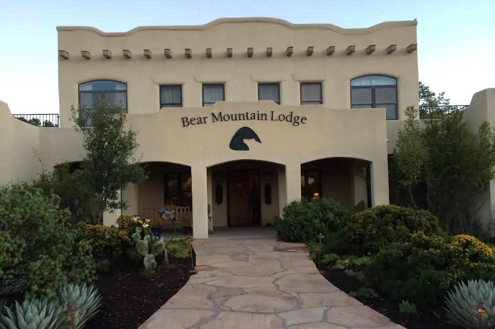 the bear mountain lodge has a stone walkway leading to it