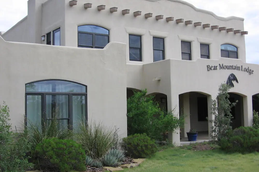 a large white building with a sign that says bear mountain lodge