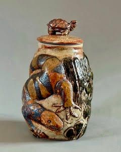 Woman with dark hair smiles at a restaurant, sitting on a ledge. Purple circle frame.