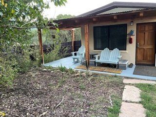 A house with a porch and chairs in front of it