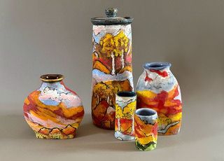 A small brown and white bird perched on a fence post